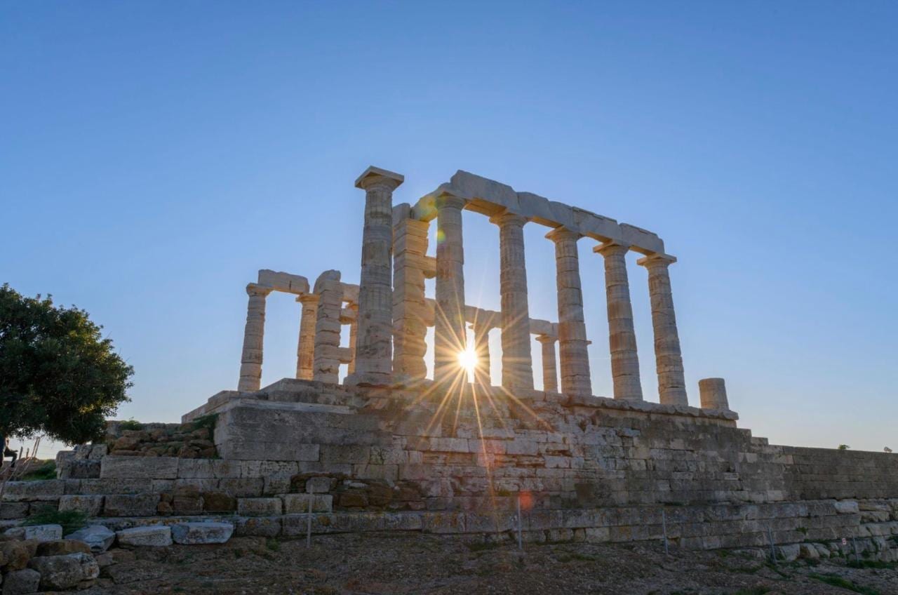 The sun starring through the Doric colonnade of the Temple of Poseidon at Cape Sounion