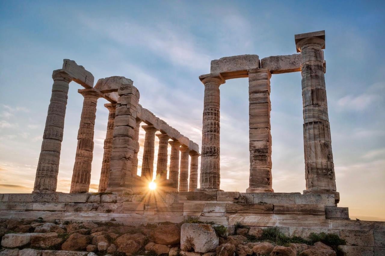 The Temple of Poseidon at Cape Sounion, its columns lit by the setting sun